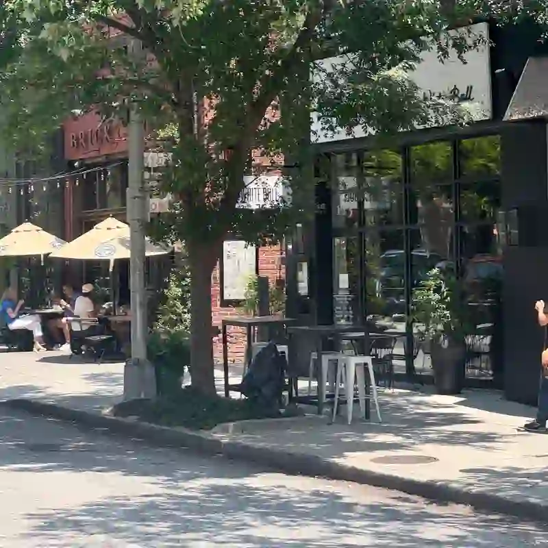 Steet-level view of restaurants, outdoor cafe seating, and shops in Decatur Square, the heart of Downtown Decatur