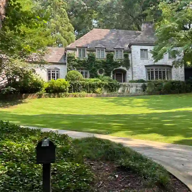 Traditional brick estate home surrounded by mature trees and landscaping in Druid Hills, Atlanta