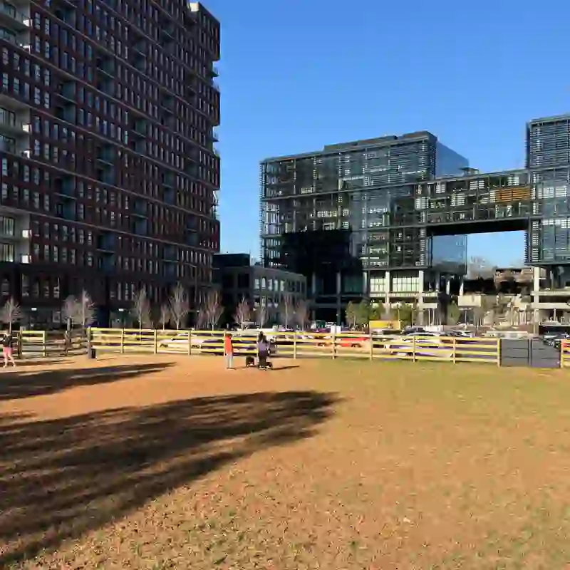 Dog park along the Atlanta BeltLine in Old Fourth Ward with modern mixed-use buildings in the background